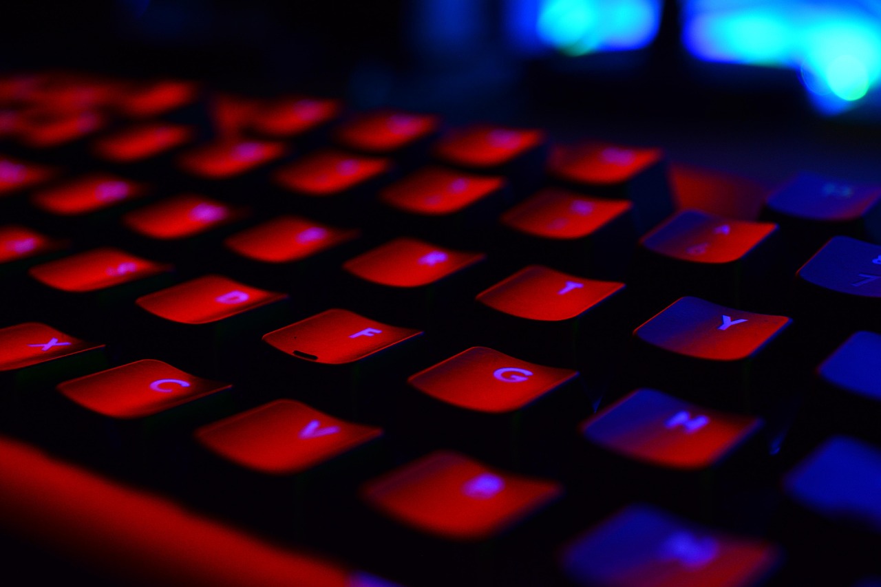 Dark gaming setup with keyboard and monitor, emphasising precision and focus